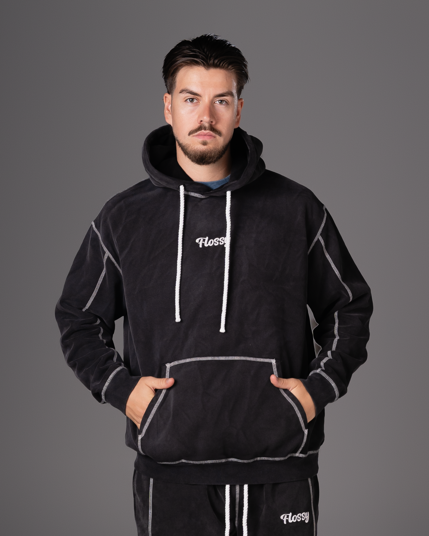 Flossy acid wash black hoodie with embroidered logo at chest, front view