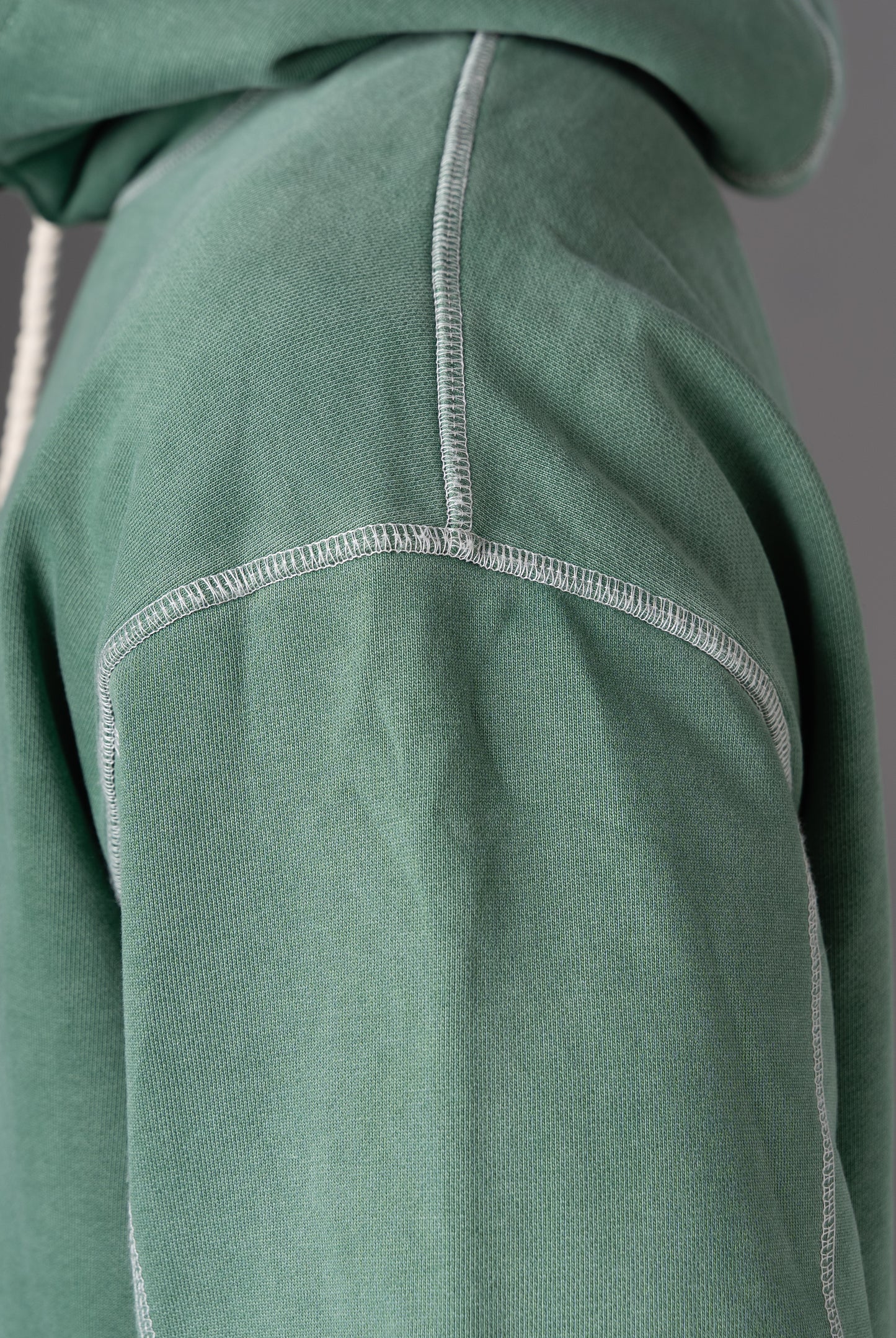 Detail shot of stitching on shoulder of Flossy acid wash green hoodie