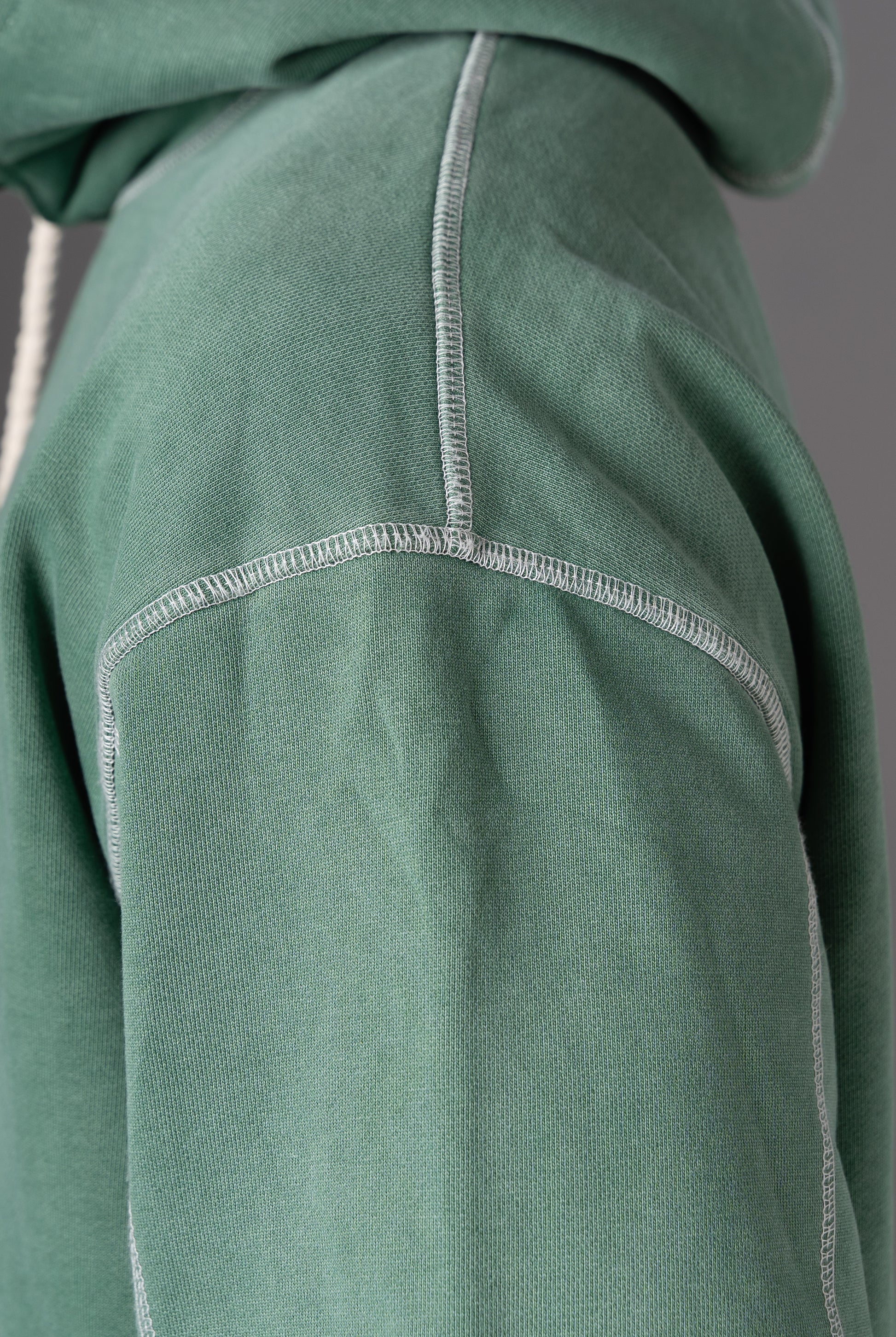 Detail shot of stitching on shoulder of Flossy acid wash green hoodie