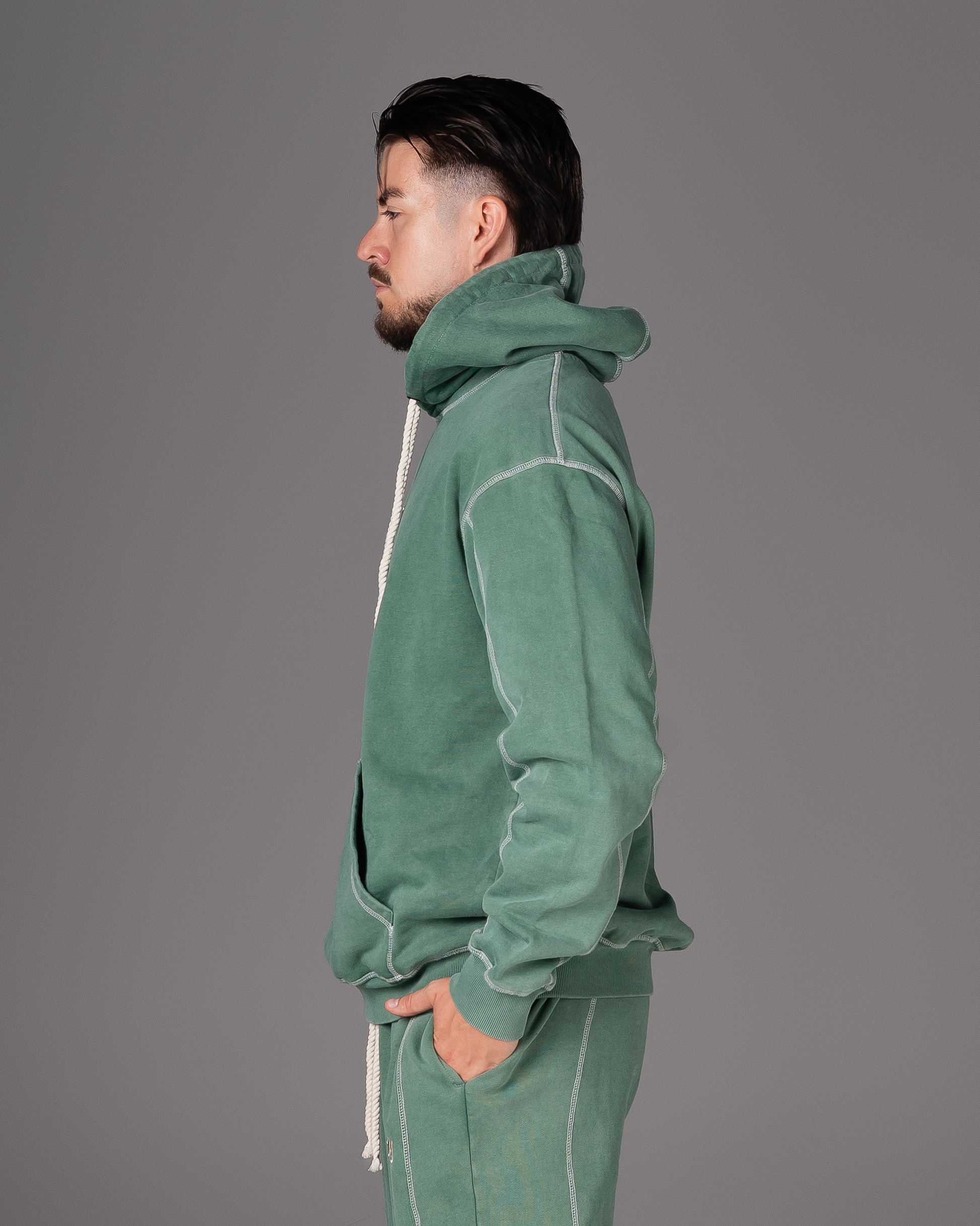 Flossy acid wash green hoodie, side profile highlighting hood and fit