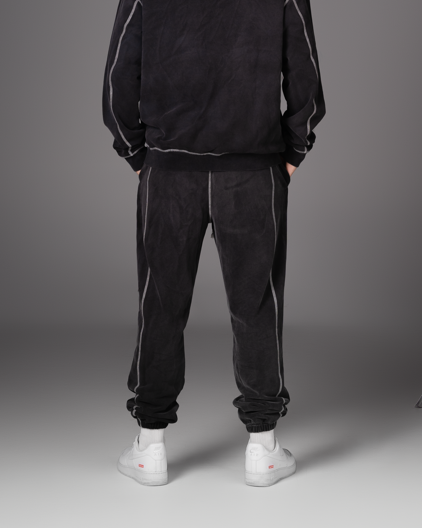 Flossy acid wash black joggers, back view showing elasticated cuffs and fit