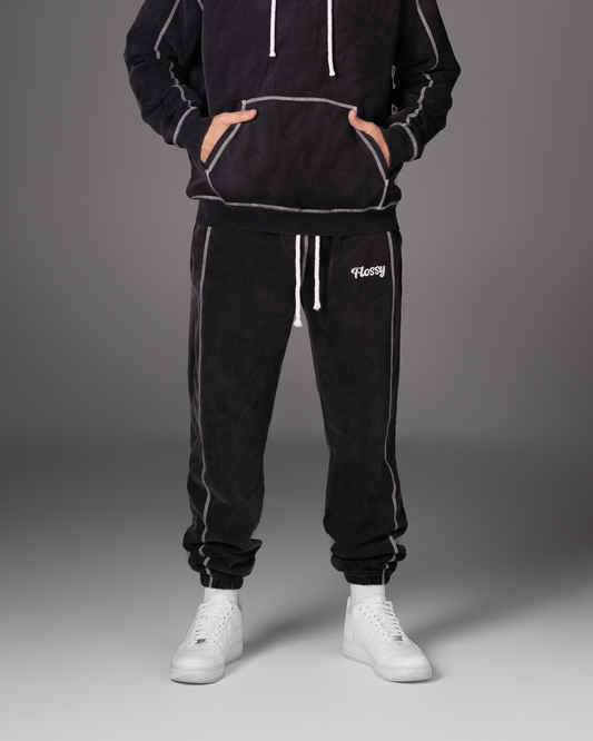 Flossy acid wash black joggers with rope drawstring and embroidered logo, front view