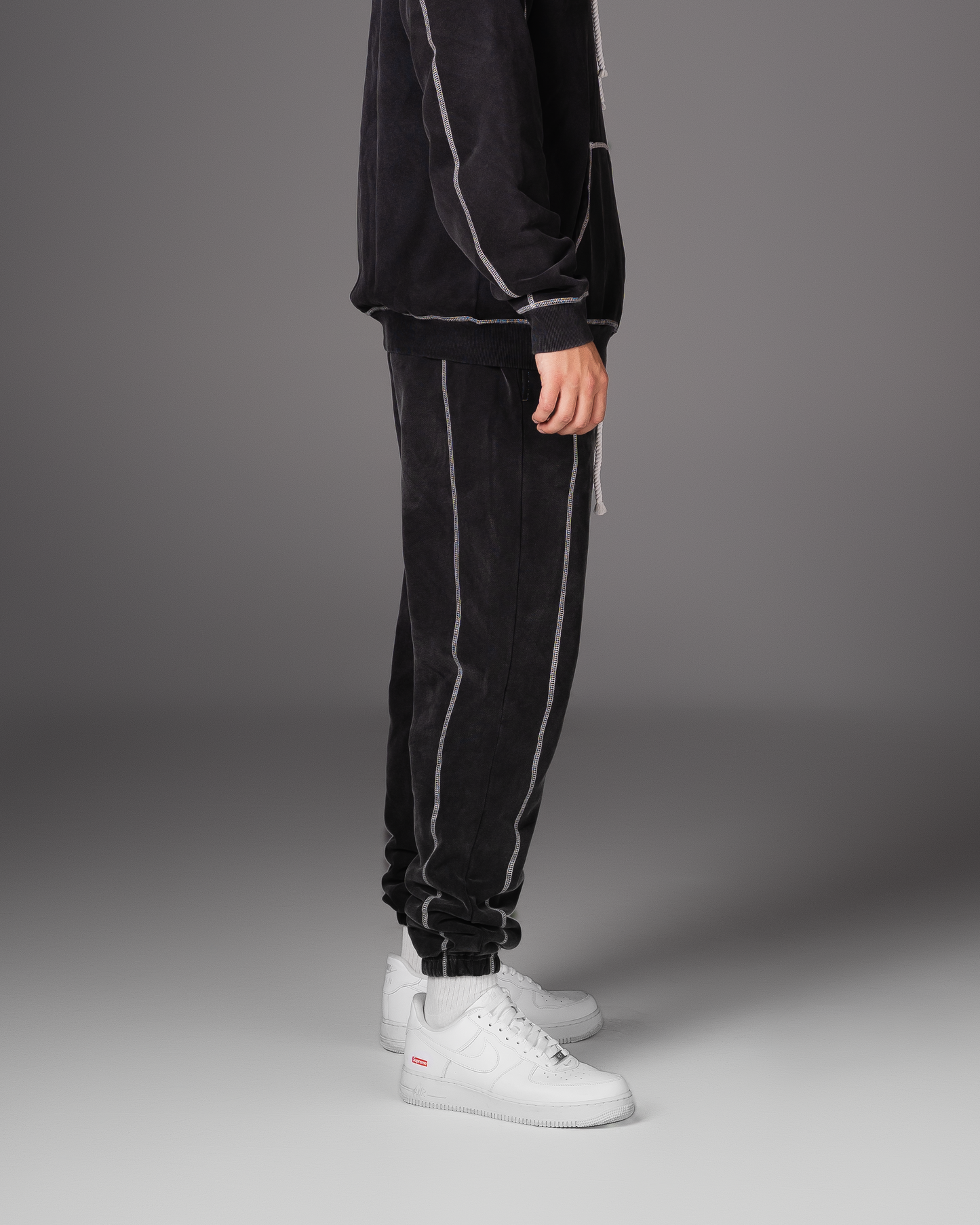 Flossy acid wash black joggers, side profile showing relaxed leg fit