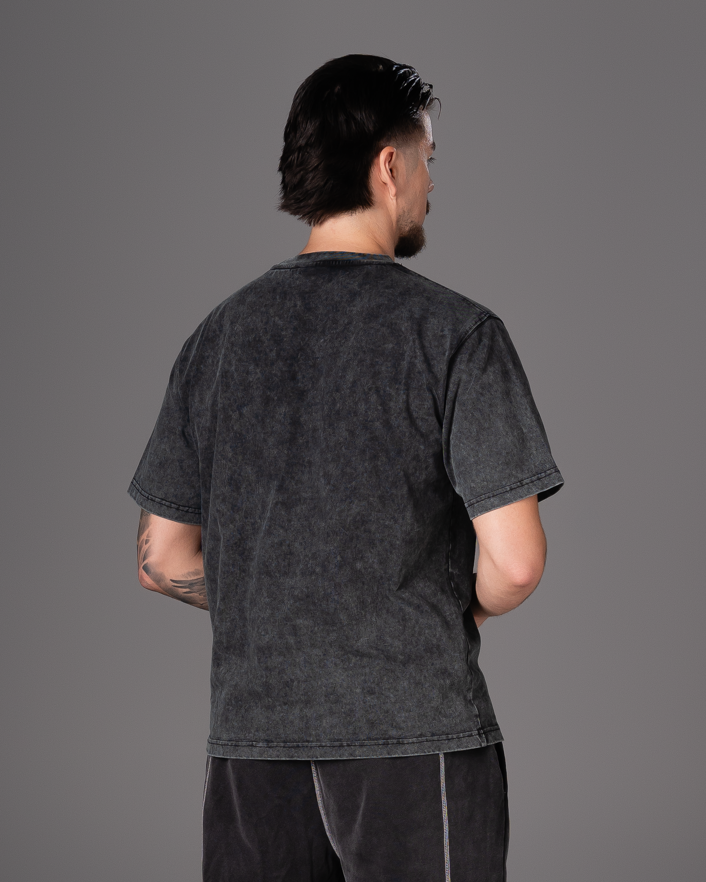 Flossy acid wash black tee, back view showcasing relaxed fit